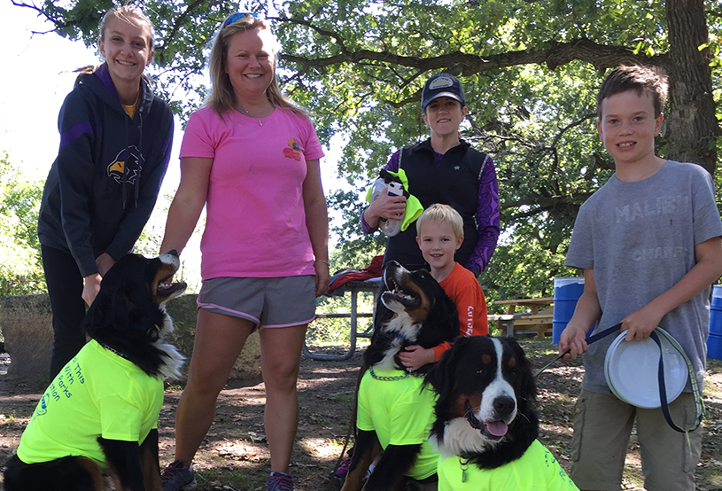 mom with kids and dogs on the hike